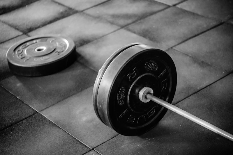 black barbell on tile flooring