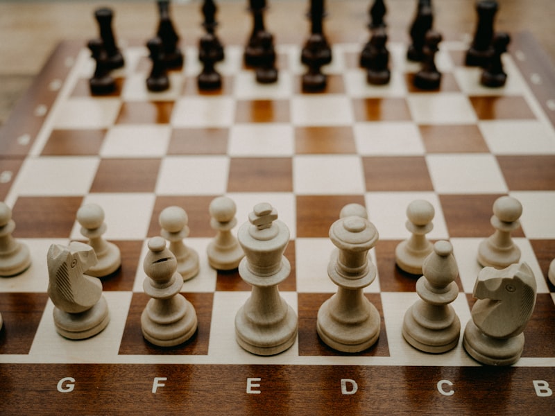 a close up of a chess board with pieces on it